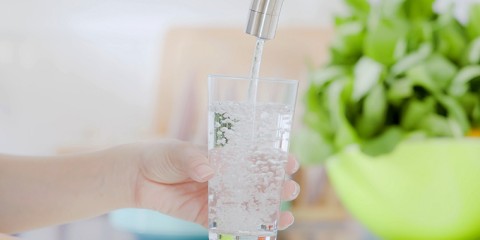 Wasser wird in Glas gefüllt.